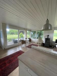 a living room with a couch and a table at Spacious Holiday Home With Large Plot By Buresø in Slangerup