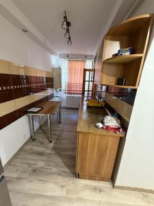 a kitchen with a desk and a table in a room at Cozy Râșnov in Râşnov