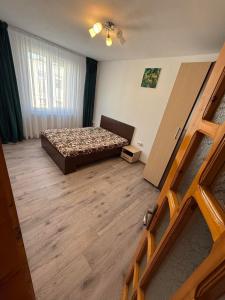 a bedroom with a bed in a room with a window at Cozy Râșnov in Râşnov