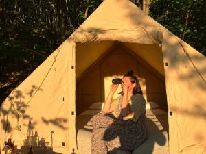 a woman taking a picture in a tent at Tenda Chirè in Garessio