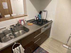 a kitchen with a sink and a counter top at Firmament Shimoshinjo in Osaka +52 photos