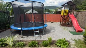 a playground with a trampoline and a slide at Penzión Hubert in Zuberec