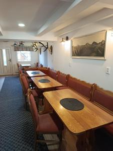 a row of tables and chairs in a restaurant at Penzión Hubert in Zuberec