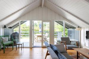 a living room with a couch and a table at Idyllic Summer House Close To Beach And Forest in Tisvildeleje