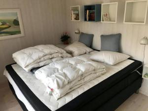 two beds with white pillows on top of each other at Fantastic House With A Beautiful View in Ebeltoft
