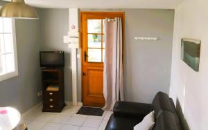 a living room with a couch and a door at Gîte de Rosemont in Saint-Pol-sur-Ternoise
