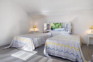 a bedroom with two beds and a window at Gîte Le Cèdre, sans vis-à-vis in Limeyrat +28 photos