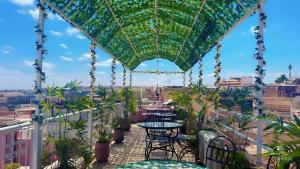 a patio with tables and chairs on a balcony at Hotel Larayhana in Fez