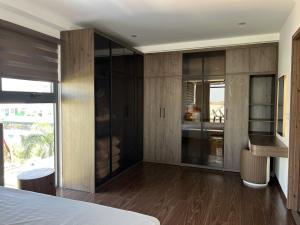 a bedroom with a bed and a large glass wall at Sky villas with large balcony in Hanoi