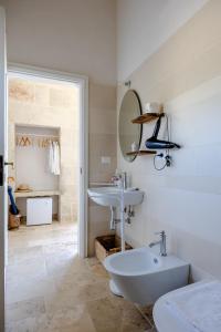 a white bathroom with a sink and a toilet at Giardino Frannicola in Maglie +85 photos