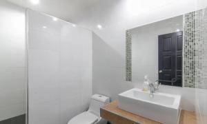 a bathroom with a sink and a toilet and a mirror at Chaiyo Riverfront Resort Phuket in Phuket +22 photos