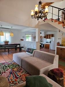 a living room with a couch and a table at Casa da Uva-Mosteiros Vineyards House-Heated swimming-pool in Mosteiros