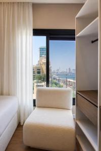 a bedroom with a bed and a large window at The Nile Residence in Cairo