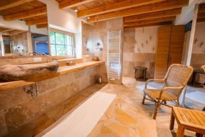 a bathroom with a sink and a chair in it at NaturQuartier am Stadtrand von Nürnberg in Stein +23 photos