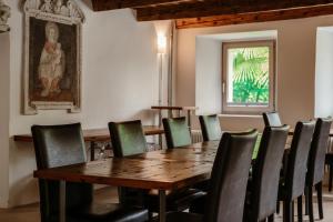 a dining room with a wooden table and chairs at Casa Martinelli, Boutique-Hotel in Maggia