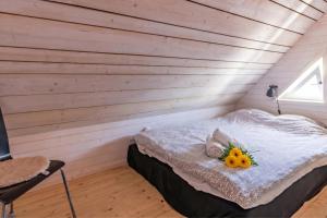a room with a bed with flowers and fruit on it at The Aspö Hideaway in Drottningskär
