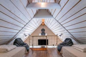 a room with two couches and a fireplace in a house at The Aspö Hideaway in Drottningskär