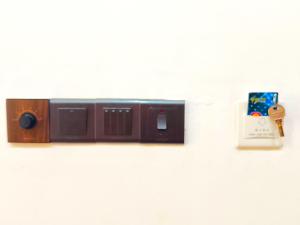 a radio on a wall with a alarm clock at Green cottage Ella in Ella