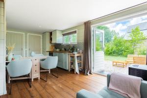 a kitchen with a large sliding glass door leading to a patio at Boshuis Luna | 4 persons in Gasselte