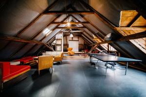 a room with a table and chairs in a attic at Penzion Sborovna in Zbraslavice