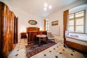 a room with a bed and a table and a table sidx sidx sidx at Penzion Sborovna in Zbraslavice +2 photos