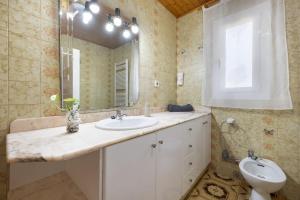 a bathroom with a sink and a toilet and a mirror at Casa Gemina in Deltebre +16 photos