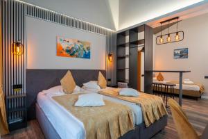a hotel room with two beds and a table at Pensiunea Warthe Bed & Breakfast in Braşov