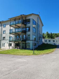 an apartment building with balconies and a parking lot at Tanhuvaaran urheiluopisto & Sport Resort in Savonlinna