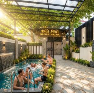 a group of people sitting in a swimming pool at Đại Nội Saphia Homestay & Villa in Hue +103 photos