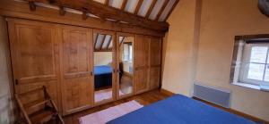a bedroom with a bed and a large wooden closet at Gite de Cerney in Marcilly-Ogny