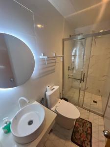 a bathroom with a toilet and a shower with a sink at Nora's Place in Panglao Island