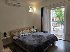 a bedroom with a bed and a door to a patio at Apartment Tome in Biograd na Moru