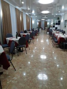 a dining room with tables and chairs in a room at Hotel Ristorante Lilia in Verona +5 photos