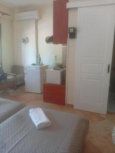 a bedroom with a bed and a white door at Evriaki Rooms Lesvos in Gera
