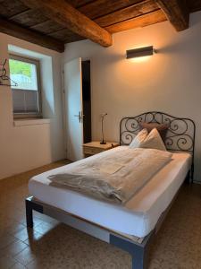 a bedroom with a large bed in a room at Casa Martinelli, Boutique-Hotel in Maggia