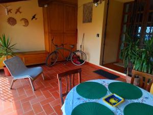 a table and chairs and a bike in a room at Poderino La Noce in Vinci +56 photos