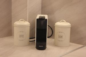a cell phone and two coffee cups on a counter at Thassos Studio Kai Lani in Potamiá