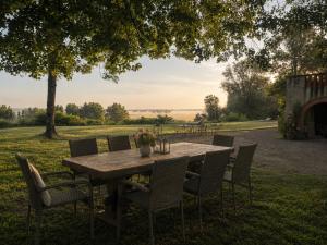 a wooden table and chairs in a field at Le Relais du Doubs en Bourgogne in Ciel