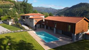 an aerial view of a house with a swimming pool at Villa Lijó Suites in Rio Caldo