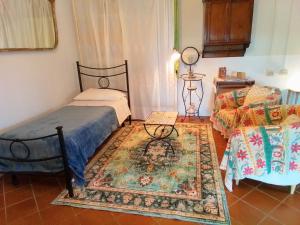 a bedroom with a bed and a rug at Poderino La Noce in Vinci