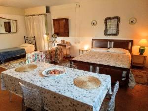 a bedroom with two beds and a table with a plate of fruit on it at Poderino La Noce in Vinci