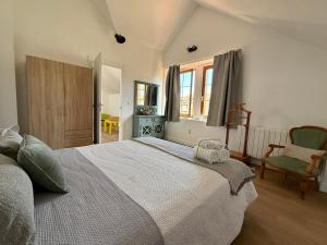 a bedroom with a large bed and a chair at Villa Las tres Mares 6826 in Noja