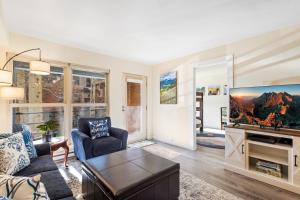 a living room with a large tv and a couch at Fall Line 107 in Telluride