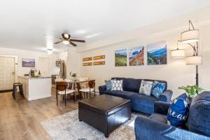 a living room with a blue couch and a table at Fall Line 107 in Telluride