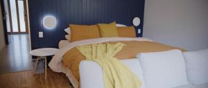 a bedroom with a large bed with yellow sheets at Tocumwal Chocolate School in Tocumwal