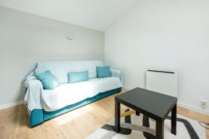 a living room with a couch and a table at Escapade Landaise, Piscine in Capbreton +17 photos