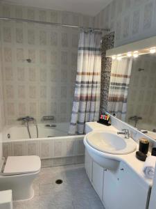 a bathroom with a sink and a tub and a toilet at Stavento Apartments in Argostoli +33 photos