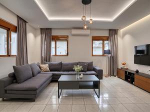 a living room with a couch and a coffee table at Azure Seaside Living in Kardamaina