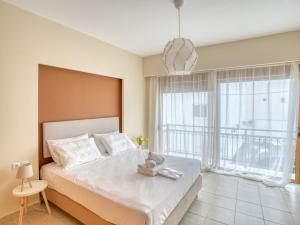 a bedroom with a large bed and a large window at Azure Seaside Living in Kardamaina