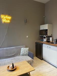 a living room with a couch and a table at Le Moderne - 2 Voyageurs in Rouen +14 photos